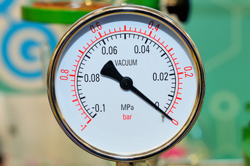Industrial pressure gauge on blurry background