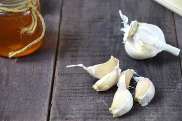 Garlic, lemon, ginger and honey, fresh and healthy food products, concept for healthy nutrition and strengthening immunity