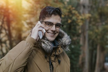 young man with outdoor mobile phone in nature