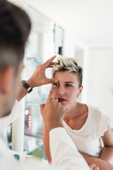 Fototapeta premium Male optometrist examining with his patient at eye clinic. 