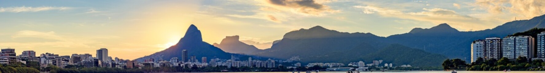 Panoramic image of the sunset seen from the lagoon Rodrigo de Freitas with the buildings of the...