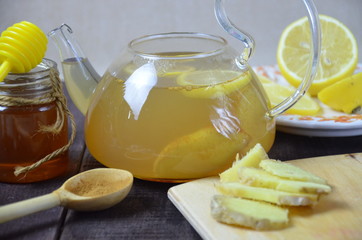 Naklejka na ściany i meble Cup of ginger tea with honey and lemon on wooden table