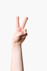 Child hand showing peace sign 