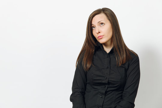 Beautiful serious upset sad caucasian young brown-hair business woman in black classic shirt, skirt isolated on white background close up. Manager, worker, student. Copy space for advertisement.