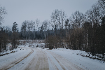 Obraz premium Winter landscape with road and forest