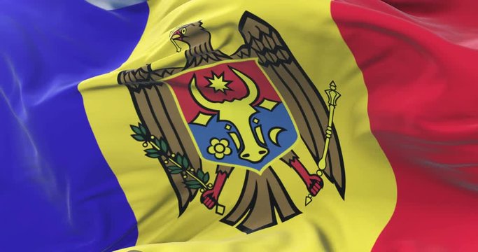 Moldova flag waving at wind in slow in blue sky, loop