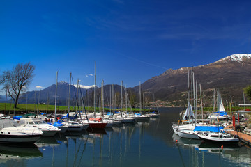 Fototapeta na wymiar Sailing boats parking in the Como lake pier