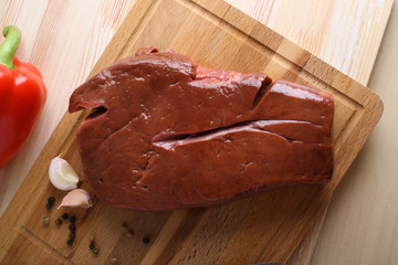 Beef liver on a wooden background