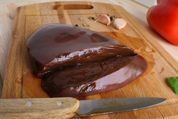 Beef liver on a wooden background