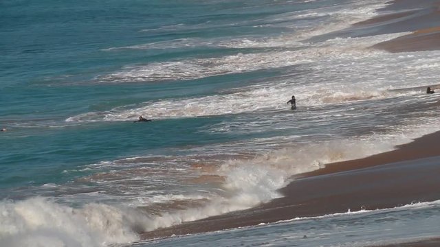 Guys surfing on El Palmar beach, on the coast of Cadiz, Andalusia, Spain