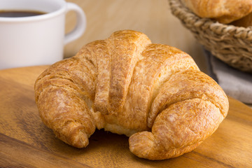 croissant on wooden cutting board