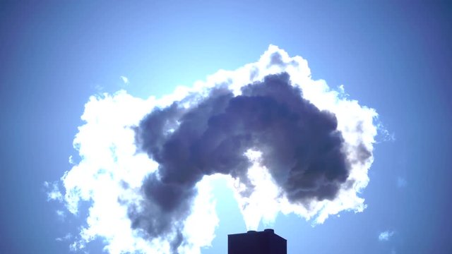 smokestacks against the background of the sun