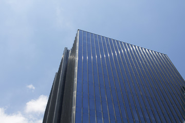 Fototapeta na wymiar Bottom view of modern, glass skyscraper.