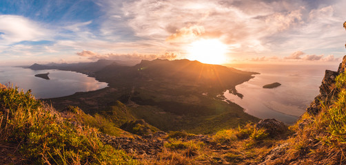 Mauritius Tropical island on top of le morne mountain facing east at sunrice with golden colors with a panoramic view on the indian ocean sea with two island in the lagoon © Christopher