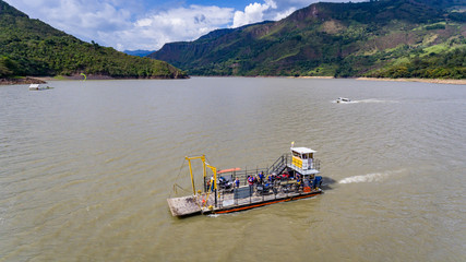 Crossing the lake by ferry in Boyaca-Colombia