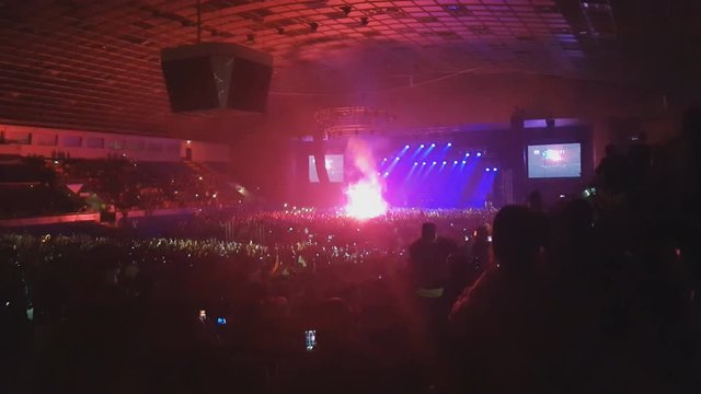 Crazy fans light up pyrotechnics during artist performance, hooligans partying