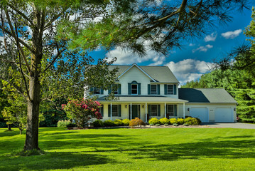 Single family home with nice lawn and blue sky