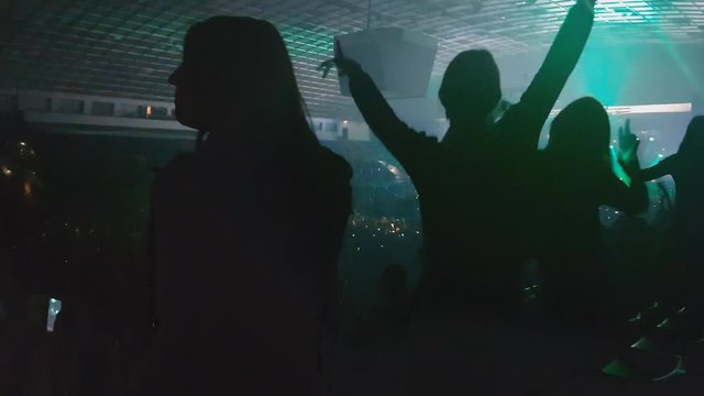 Crazy fangirls jump at concert to favoutite song, enjoyment, satisfaction