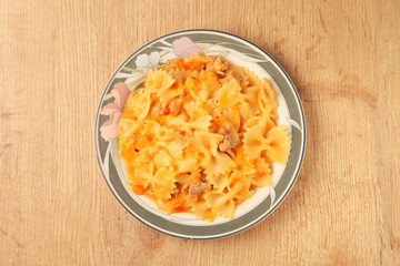 Italian pasta - farfalle with chicken and tomato sauce  