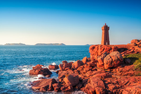Ploumanach lighthouse sunset in pink granite coast, Brittany, France.