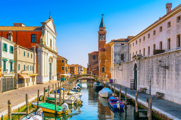 Chioggia town in venetian lagoon, water canal and church. Veneto, Italy - obrazy, fototapety, plakaty