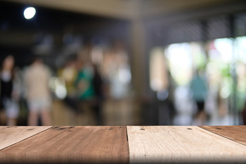 Empty wooden table top with blurred restaurant, abstract background