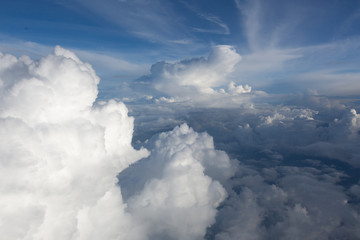 Aerial view on clouds and blue sky from airplane window