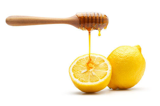 Honey Dripping On Fresh Lemon Isolated On White Background