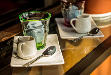 Clear colorful glass cups of Affogato coffee or espresso shot with ice cream on glass counter bar.Homemade organic blue ice cream made from butterfly pea flowers.