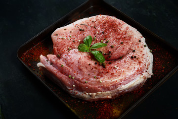 Fototapeta na wymiar raw meat on a baking sheet on a wooden background