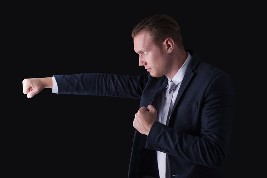 Businessman ready to fighting stance against competitor a white background
