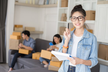 Asian woman holding box with attractive smiling . People with SME, Delivery, Online Business concept.