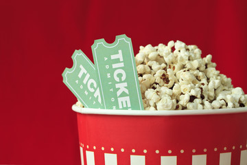 Popcorn Bag And Movie Ticket On Red Background