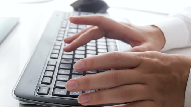 Closeup 4k pan footage of businesswoman typing message on computer keyboard