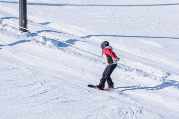 People are having fun in downhill skiing and snowboarding