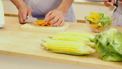 Young Asian Couple having fun Preparing Food, vegetable and salad in the Kitchen