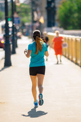 Girl Running or Jogging at the City Downtown