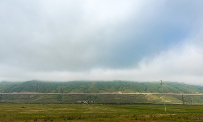 Fototapeta na wymiar Fog over green mountains