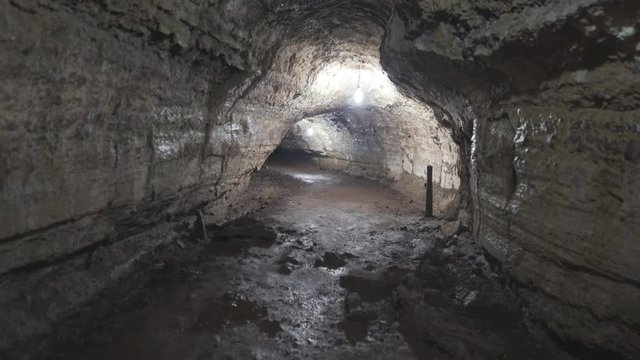 a 3 axis gimbal shot walking through a lava tube on isla santa cruz in the galapagos islands, ecuador