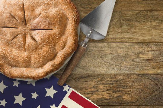 Pie and server on wood table with american flag table runner