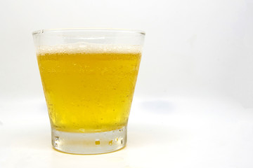 Close up beer glass has beer in the glass on whith background
