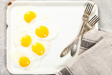 Fried eggs on a baking sheet.