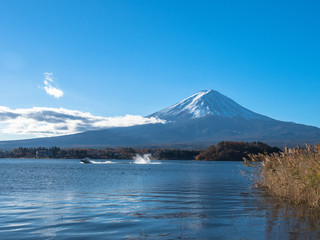 Fuji mountain with the boats and tourist are boating in the lake.