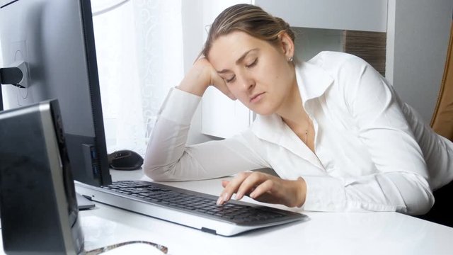 4k video of young elegant businesswoman got tired on work and falling asleep behind office desk