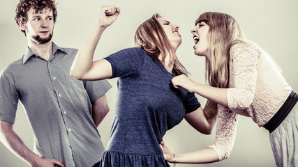 Aggressive mad women fighting over man.