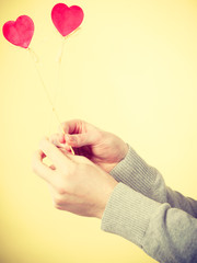 Two hands with love symbols.