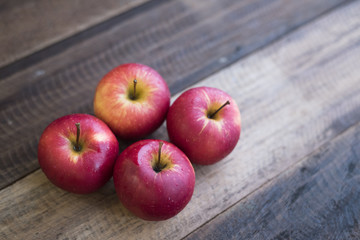 group of red apple on a wooden table