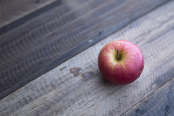 red apple on a wooden table
