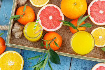 Different fruits and glass with fresh orange juice
