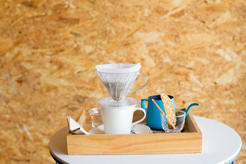 Cup of Dripping fresh hot coffee on the paper filter in cafe